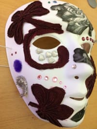 The mask that Tracey made, white with gemstones